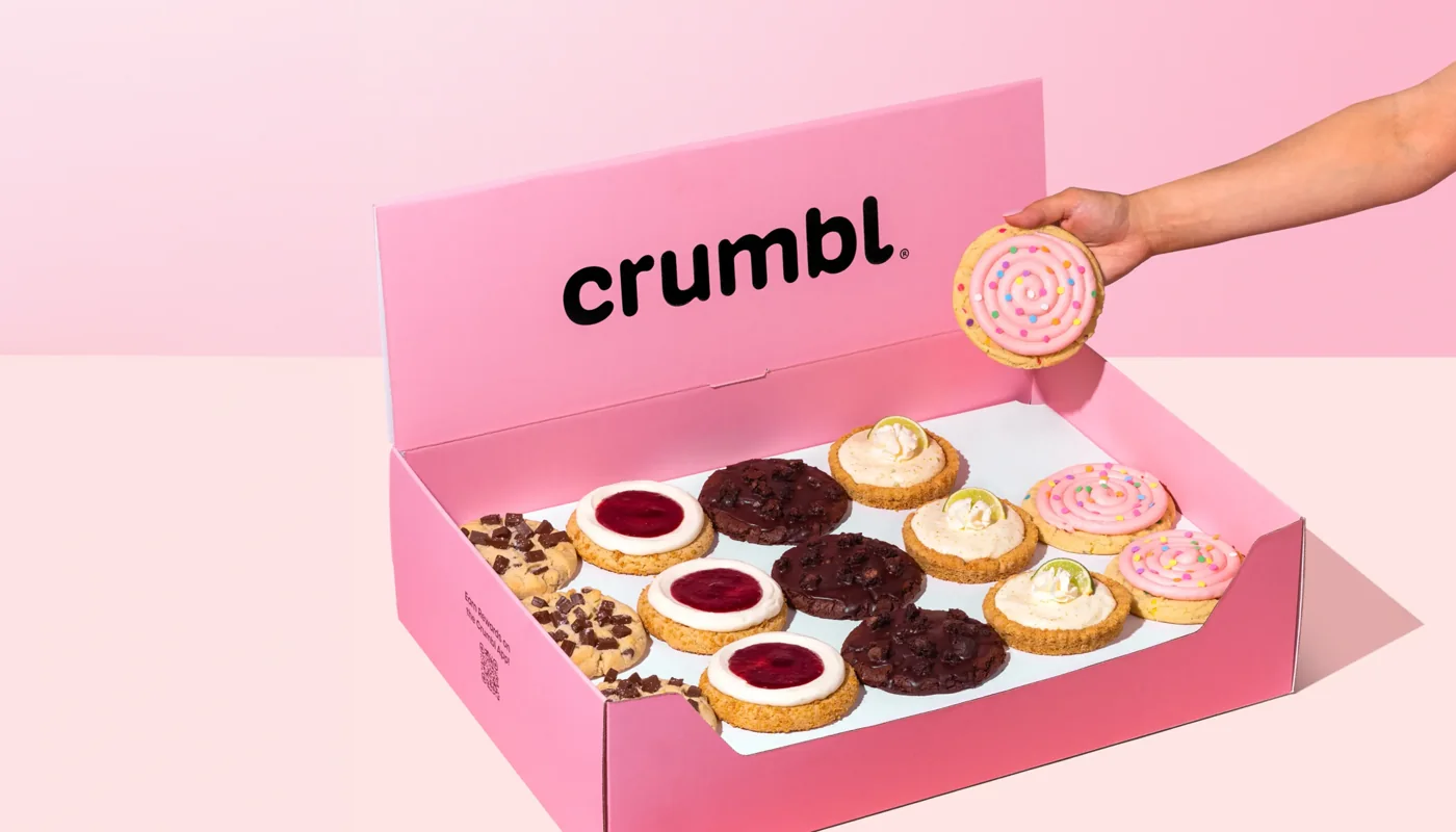 Crumbl’s pink cookie box with a selection of cookies